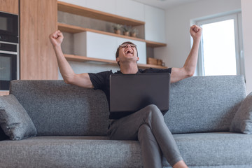 emotional man watching video on his laptop.