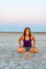 Fototapeta na wymiar Beautiful Woman Doing Handstands In The Bonneville Salt Flats