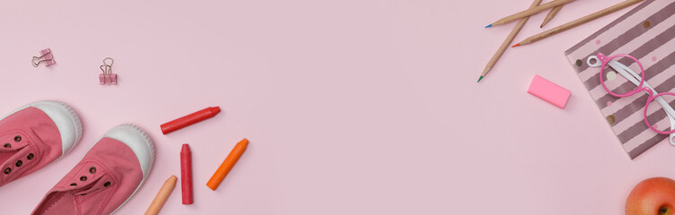 Creative flatlay of education pink table with student books, shoes, colorful crayon, eye glasses, empty space in studio shot isolated on pink long banner background, Concept of education