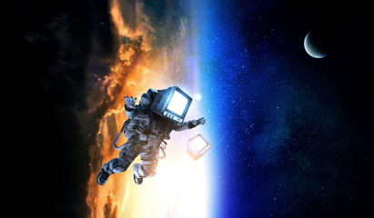 Obraz na płótnie Canvas Monitor headed astronaut . Mixed media