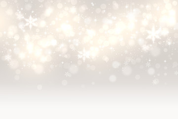 金色と銀色を背景とした光輝く雪の結晶