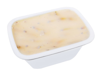 Cream cheese with mushrooms in a plastic container isolated macro