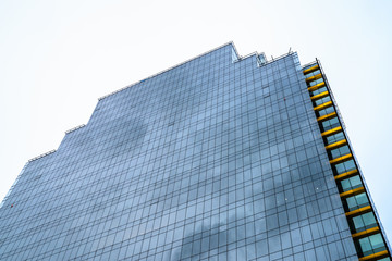 Naklejka premium Low Angle View Of Tall Corporate Building