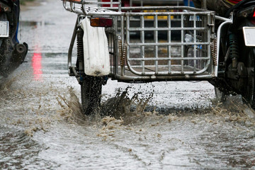 motion motorcycle  rain big dirty puddle of water spray from the wheels