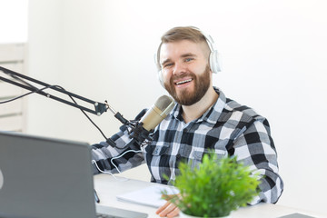 Music, dj, blogging and broadcasting concept - Male radio host with a funny expression