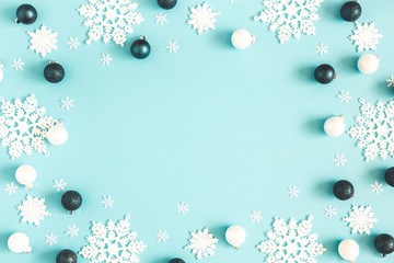 Christmas or winter composition. Frame made of snowflakes on pastel blue background. Christmas, winter, new year concept. Flat lay, top view, copy space