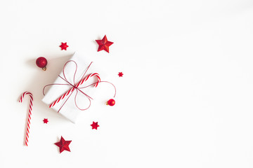 Christmas composition. Gift box, red decorations on white background. Christmas, winter, new year concept. Flat lay, top view, copy space