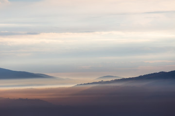 A view of Umbria valley with hills and fog