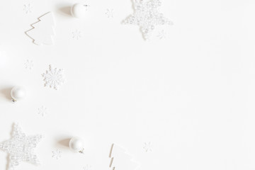 Christmas composition. Frame made of white decorations on white background. Christmas, winter, new year concept. Flat lay, top view, copy space