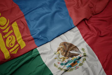 Naklejka premium waving colorful flag of mexico and national flag of mongolia. macro