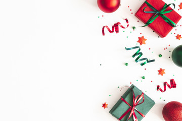 Obraz premium Christmas composition. Gifts, red and green decorations on white background. Christmas, winter, new year concept. Flat lay, top view, copy space