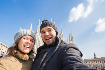 Fototapeta na wymiar Couple taking self portrait in Duomo square in Milan. Traveling and relationship concept