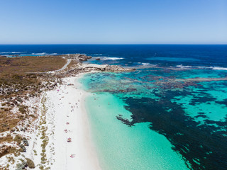 Beautiful drone shot of the ocean, beach and reef over little Salmon bay on Rottnest Island, Perth on a stunning summers day of sun and calm sea.