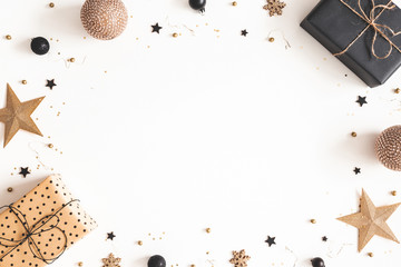 Christmas composition. Gift box, beige and black decorations on white background. Christmas, winter, new year concept. Flat lay, top view, copy space