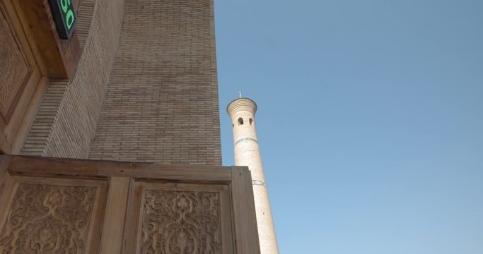 Muslim religious complex, mausoleum Hazrati Imam in Tashkent, Uzbekistan. The minarets that are close to the mosque about 50 meters high. Part of the medrese is now occupied by artisans. BMPCC4K