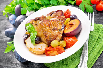 Chicken with fruits and tomatoes in plate on table