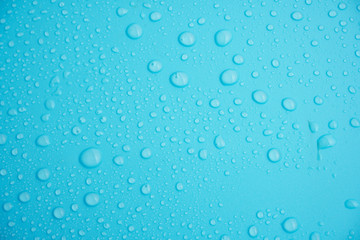 Plakat Water drops on blue background.