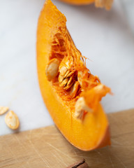 pumpkins with cinnamon sticks on marble backgrund