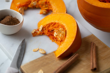 pumpkins with cinnamon sticks on marble backgrund