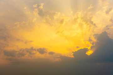 Dramatic warm sunset sky and clouds with ray light. Nature background.