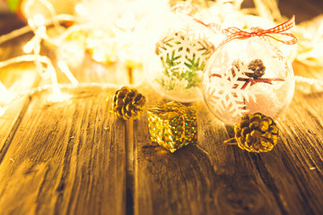 Christmas ball on a wooden table over christmas lights background