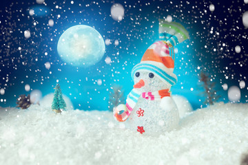 Christmas snowman with Xmas lights and snow on moonlights. The elements of this image furnished by NASA