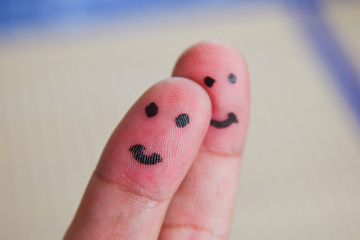 Couple finger art of loving while smiley face.