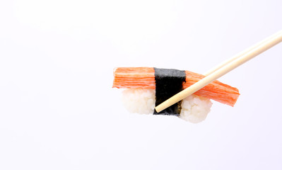 Sushi with chopsticks isolated on a white background.