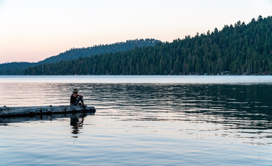 Fototapeta premium Woman Fishing in Lake Tahoe During Sunset