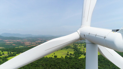 Wind turbine is alternative electrical power with blue sky, summer field, renewable energy