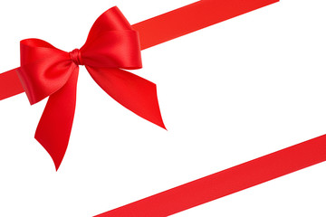 Awesome bright handmade gift creative bow and two red shiny diagonal silk ribbons at the corners of...