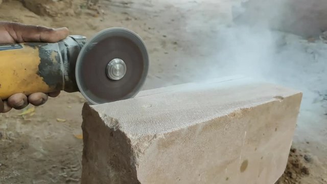 Stone cutting video by hand holding cutter machine