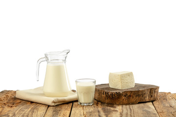 Different milk products, cheese, cream, milk on wooden table and white background. Healthy eating and lifestyle, organic natural nutrition, diet. Delicious food and drinks.