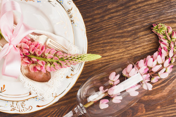 Obraz na płótnie Canvas Tableware with pink lupines and silverware