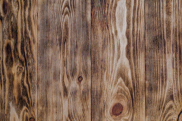Fototapeta premium Wooden background or texture. Burnt wood with knots