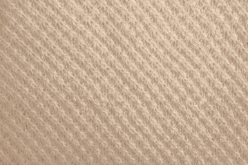 Obraz premium The tail is made of beige knitted fabric texture. Machine knitting texture close up Photo. Beige grey knitted background. the texture of the warm fabric