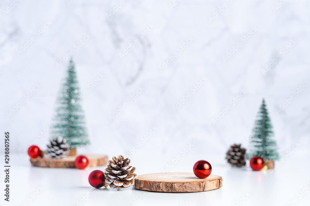 Poster christmas tree with pine cone and decor xmas ball and empty wood log plate on white table and marble