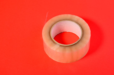 Scotch tape roll on a red background