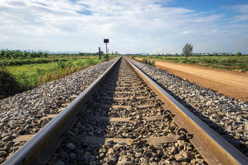 Photography of railway tracks in a rural scene.