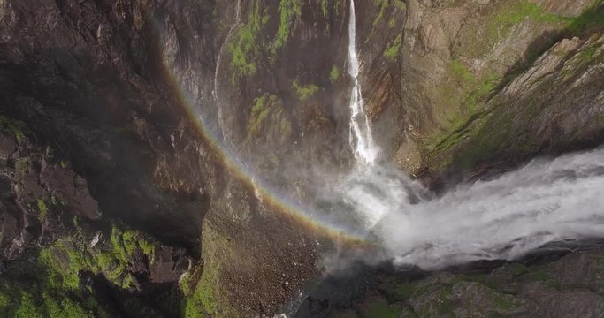 Lifting up over waterfall with rainbow