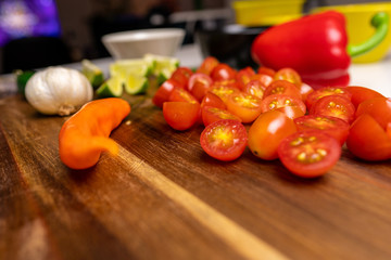 Close up of a cutting board with  a selection of healthy vegetables and fruit on a wooden cutting board