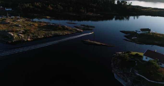 Aerial footage of speed booat crossing peaceful blue water near bautiful island. 