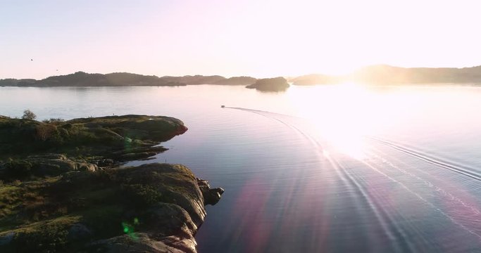Aerial footage of speed booat crossing peaceful blue water near bautiful island. 