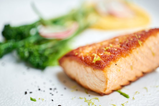 Salmon steak fillet and garnished with young broccoli. Restaurant menu, a series of photos of different dishes