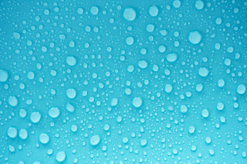 Naklejka na ściany i meble Water drops on blue background.
