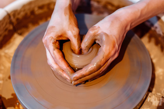 girl sculpts from clay in a workshop on a lathe