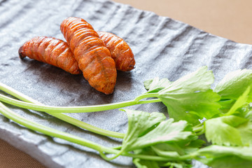 Insect food for fried Worm with vegetables in the brown plate. Healthy meal high protein diet concept. Closeup,