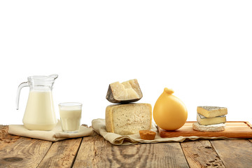 Different milk products, cheese, cream, milk on wooden table and white background. Healthy eating and lifestyle, organic natural nutrition, diet. Delicious food and drinks.