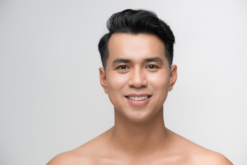 Photo of smiling mature man standing isolated over white wall background naked. Looking camera.
