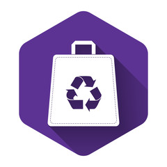 White Paper shopping bag with recycle icon isolated with long shadow. Bag with recycling symbol. Purple hexagon button. Vector Illustration
